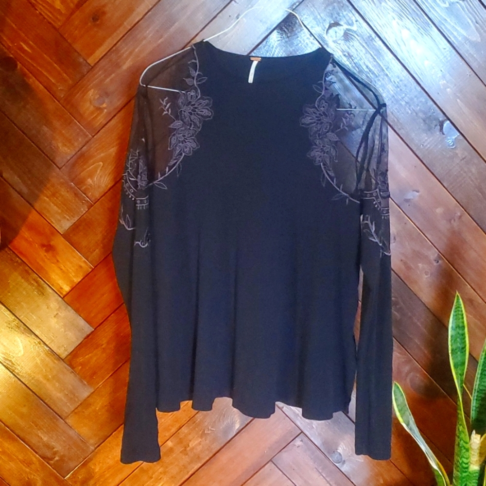 Free people black embroidered top with sheer shoulder panels.